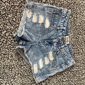 Distressed blue and white jean shorts.